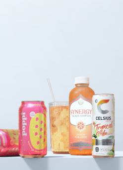 Cans of Poppi, a bottle of Synergy tea, and a Celsius energy drink.