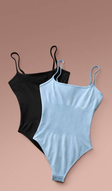 Two seamless bodysuits, one black and one light blue, layered against a neutral background.