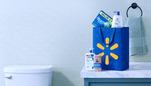 A Walmart reusable bag with personal care items on top of a bathroom countertop.