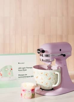 A pink and floral mixer, a floral mug, and an LED face mask.